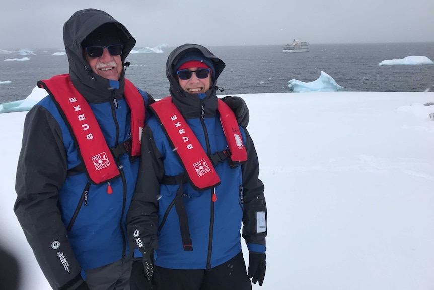 Jesz and Madge Fleming stand in warm weather gear in Antarctica