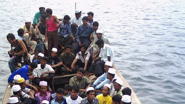 A wooden boat carrying Myanmarese asylum seekers arrive at the Indonesian Sabang island.