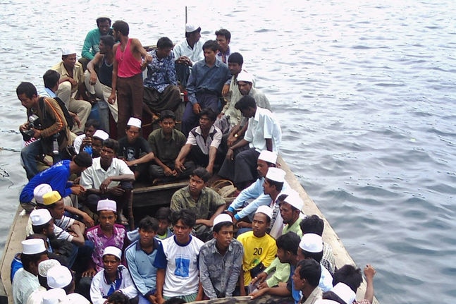A wooden boat carrying Myanmarese asylum seekers arrive at the Indonesian Sabang island.