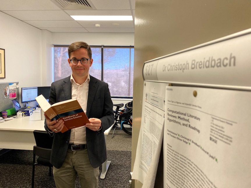 Dr Christoph Breidbach standing in his office. 