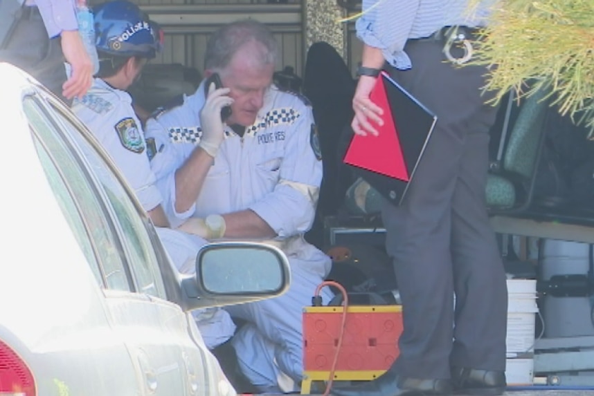 Police inspect a bomb found at Penrith