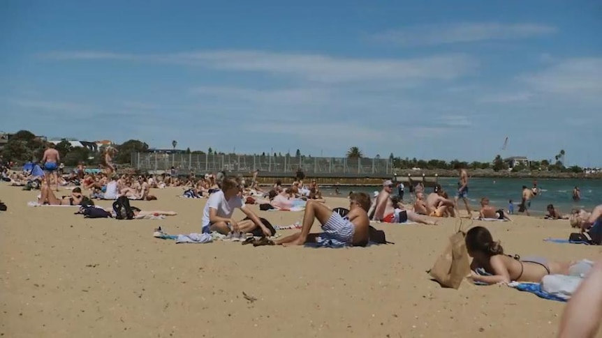 Crowd of people sitting on beach