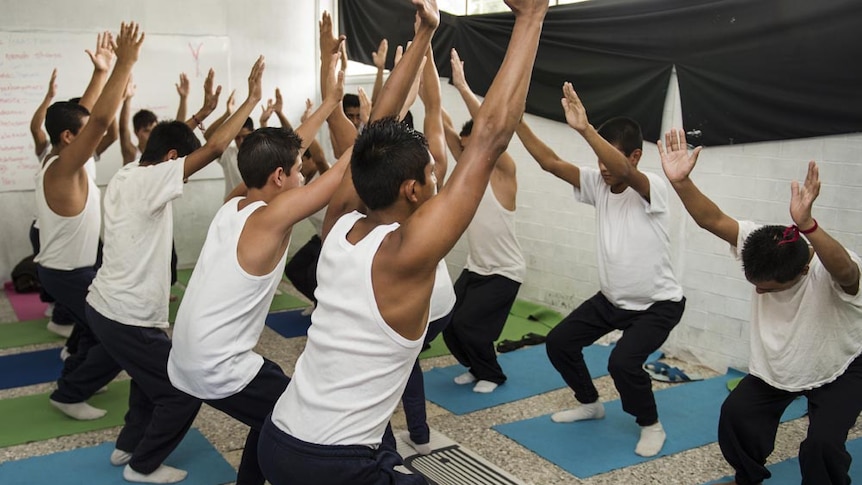 Teenagers facing homicide and robbery charges practice yoga in a young offenders' institution in Mexico City