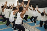 Teenagers facing homicide and robbery charges practice yoga in a young offenders' institution in Mexico City