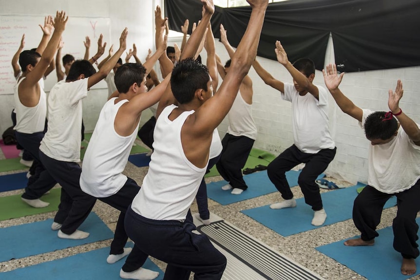 Teenagers facing homicide and robbery charges practice yoga in a young offenders' institution in Mexico City