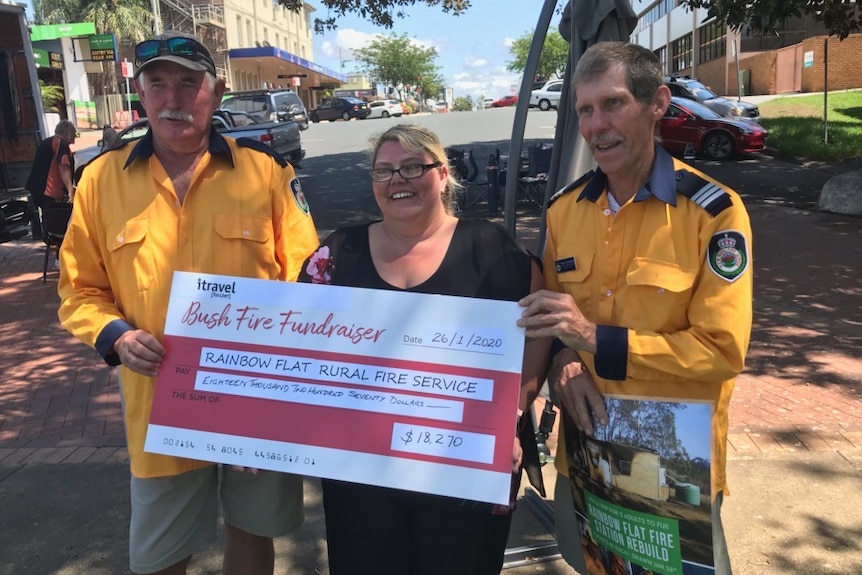 Three people with a novelty cheque