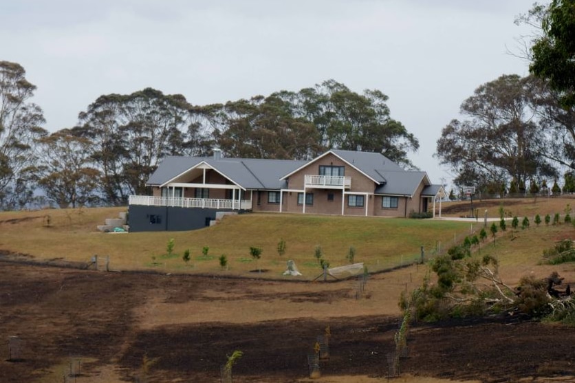 Newly built, large stately home onlarge rural block is surrounded by tall gum trees and burnt grassy paddocks