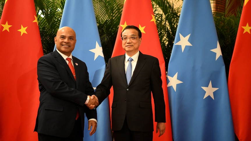 China’s Premier Li Keqiang shakes hands with Micronesia's President David Panuelo at the Great Hall of the People in Beijing