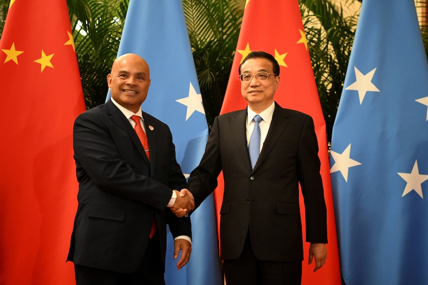 China’s Premier Li Keqiang shakes hands with Micronesia's President David Panuelo at the Great Hall of the People in Beijing