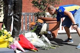 Flowers laid at the base of Richie Benaud's statue at the SCG