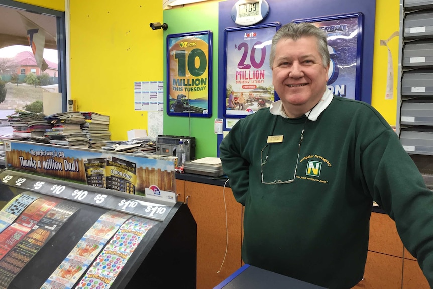 Lachlan Sullivan behind the counter in his newagency