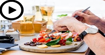 A person eats a brightly-coloured meal