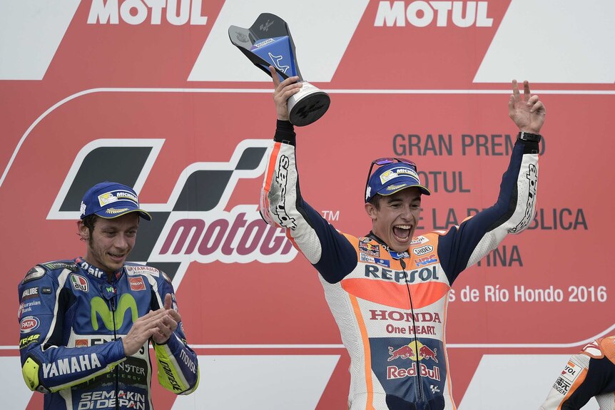 Marc Marquez celebrates next to Valentino Rossi