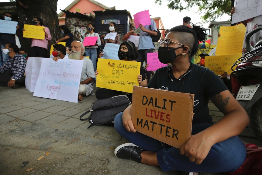 People at a protest holding signs reading 'Dalit lives matter'