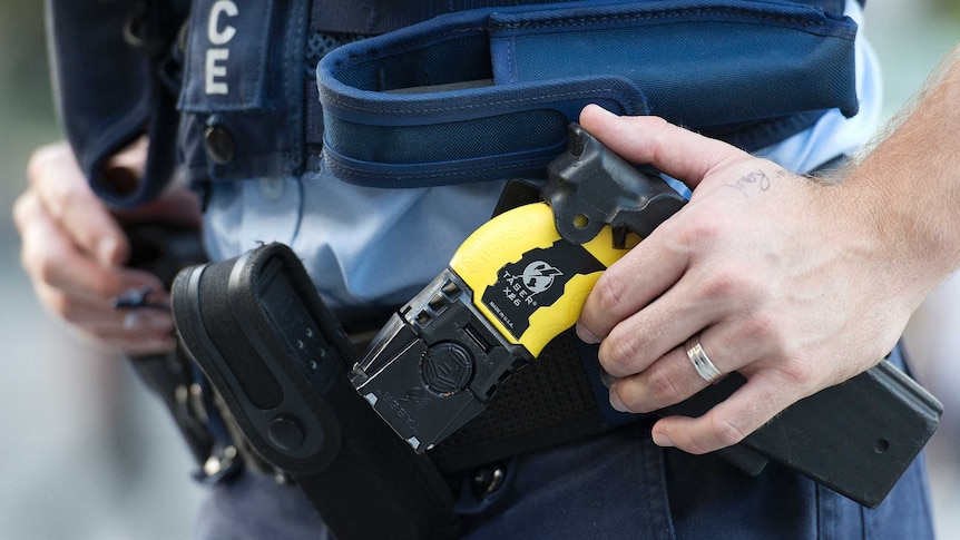 A taser on the belt of a police officer.