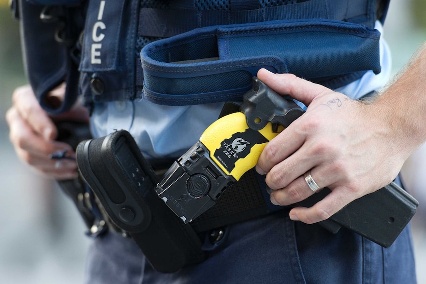 A taser on the belt of a police officer.