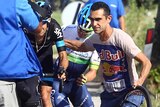 Cyclist Richie Porte (on bike) is helped by fellow Australian rider Simon Clarke at Giro d'Italia.