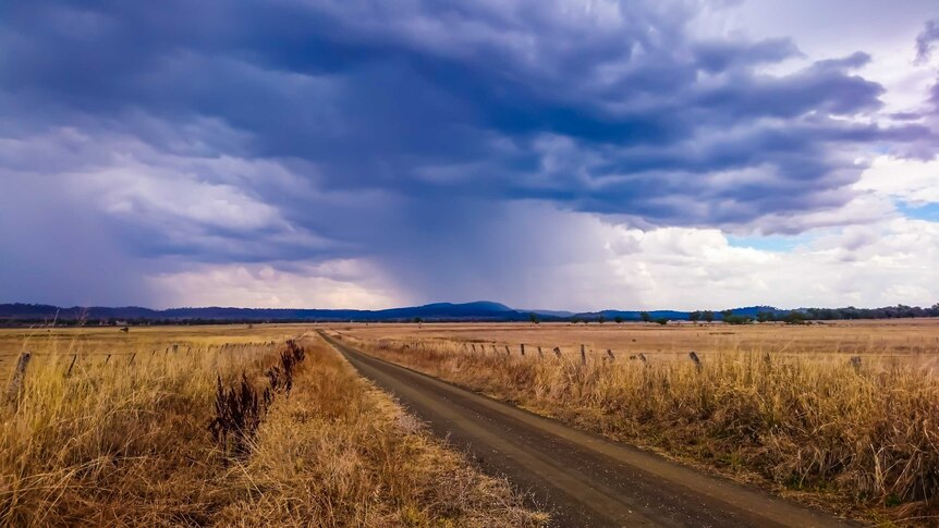 Storm clouds on the horizon over a rural area.