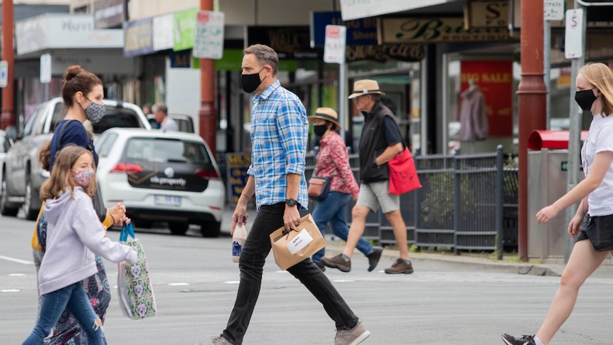 People on the street wearing masks.