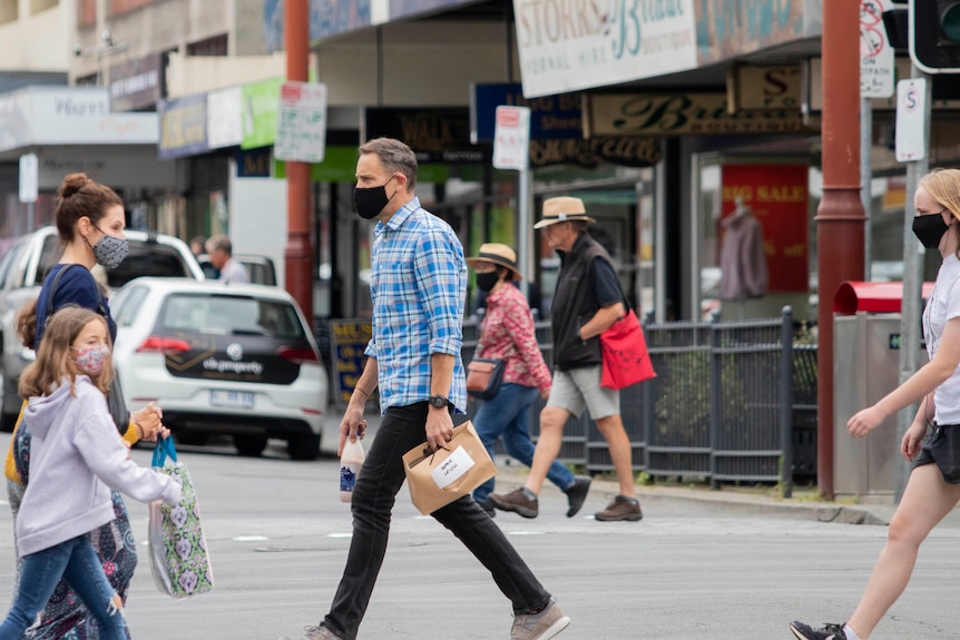 People on the street wearing masks.