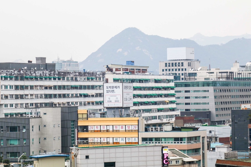 an industrial landscape against a mountainous background