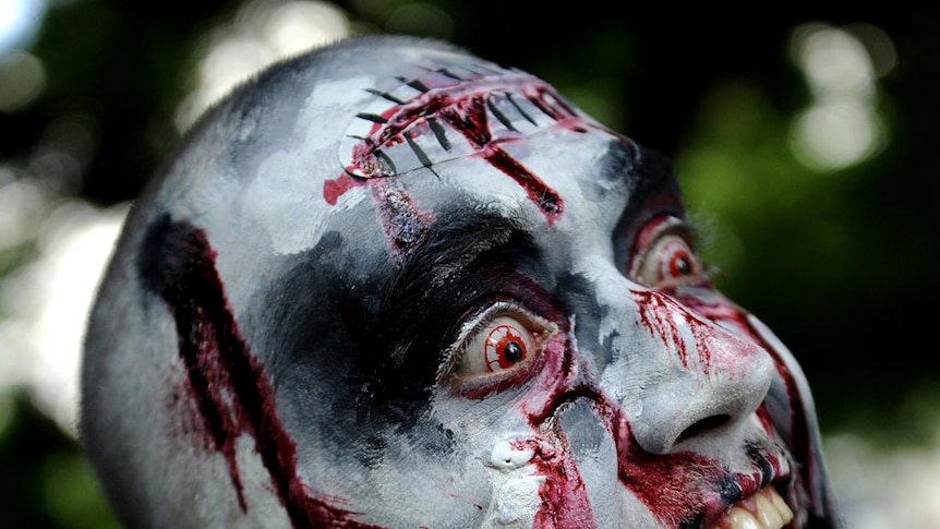 A man dressed as zombie takes part in a zombie walk