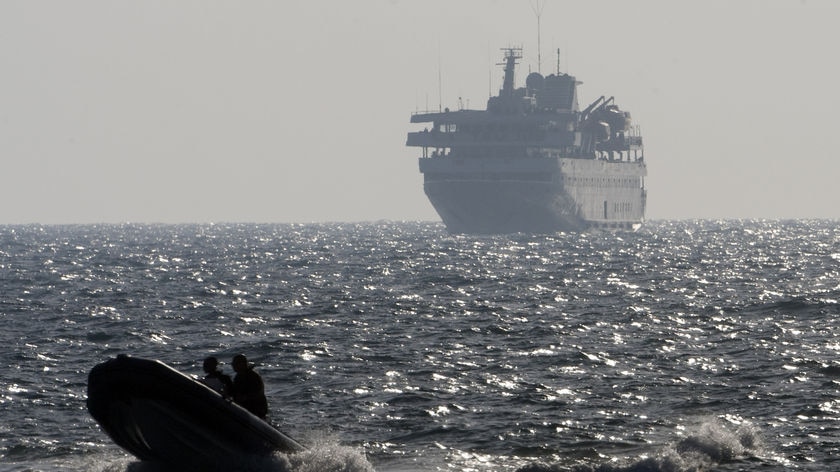 An Israeli speed boat escorts Turkish ship Mavi Marmara into port following fatal raid.