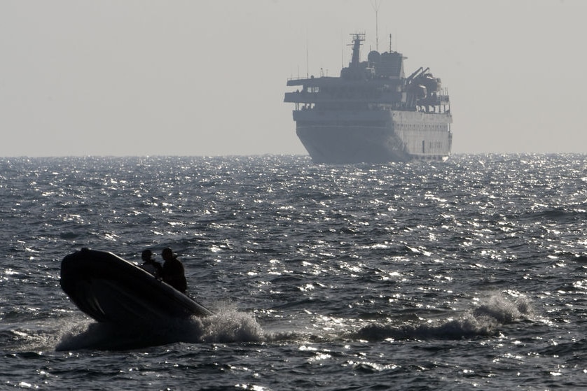 An Israeli speed boat escorts Turkish ship Mavi Marmara into port following fatal raid. (AFP: Menahem Kahana)