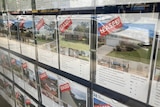A real estate agency window showing rental properties that have been leased.