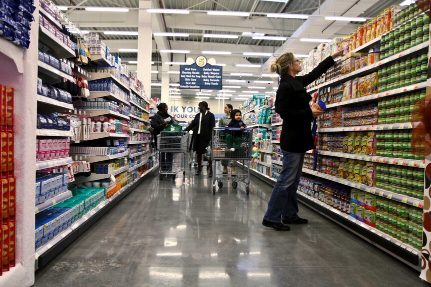 People shopping in supermarket aisles