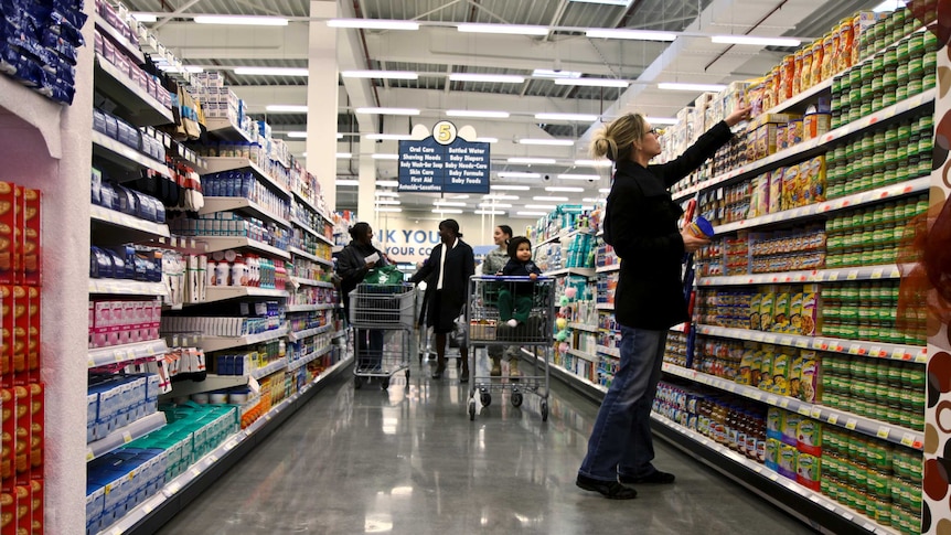 People shopping in supermarket aisles