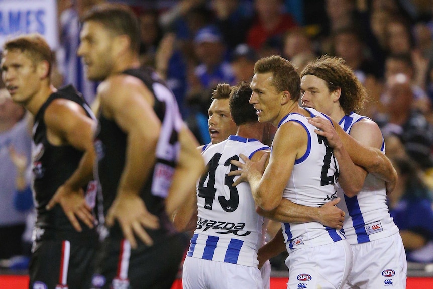 Drew Petrie celebrates a goal in his 300th game for North Melbourne