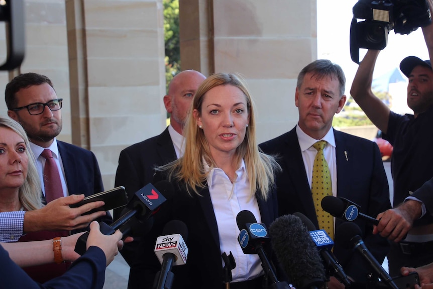 WA Nationals Leader Mia Davies stands on the steps of Parliament surrounded by journalists.