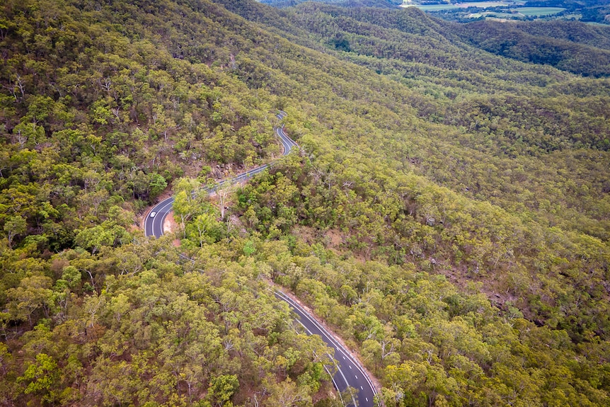 aerial view of mountain road with multiple bends