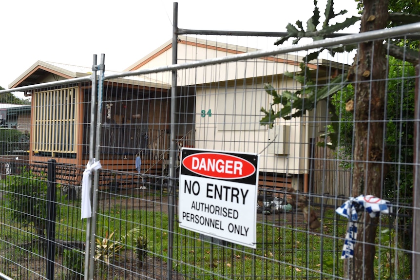A fence surrounds a house in which eight children were allegedly murdered in the suburb of Manoora.