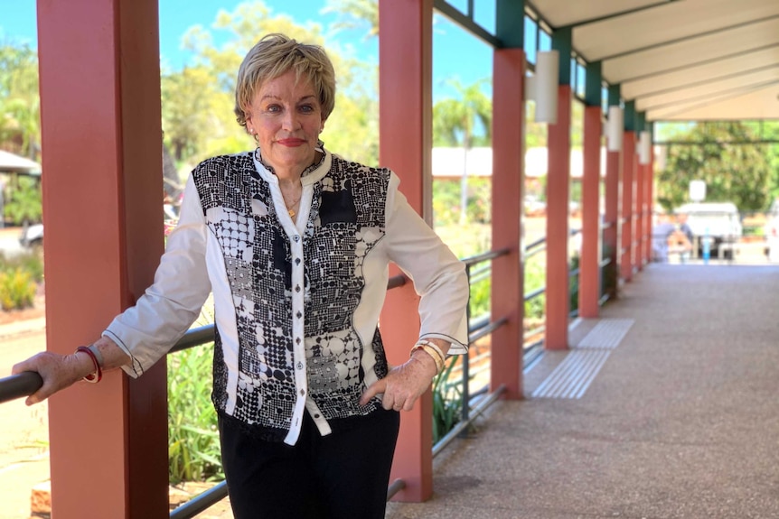 WA Regional Development Minister Alannah MacTiernan on a veranda with very blue sky behind her. She's leaning against a pole