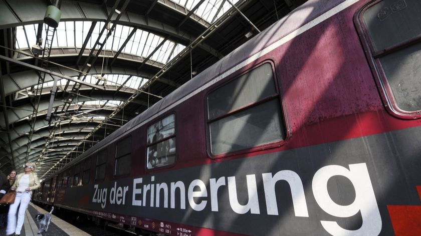 A woman walks past the so-called 'Zug der Erinnerung' (Memory Train)