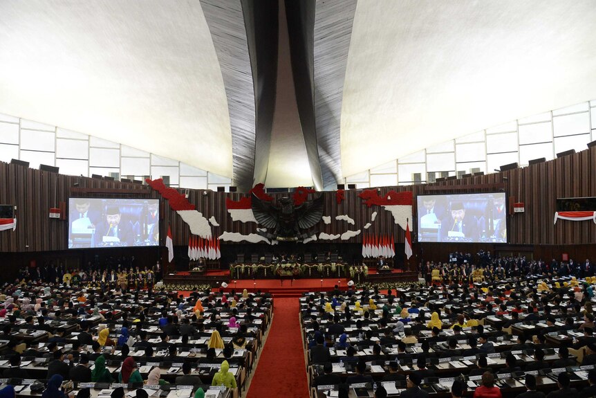 Photo shows Indonesia's parliament from the inside with a map of the archipelago up the front.
