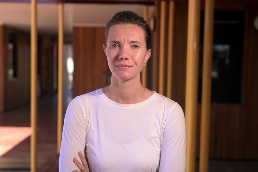 A woman staring grimly at a camera.