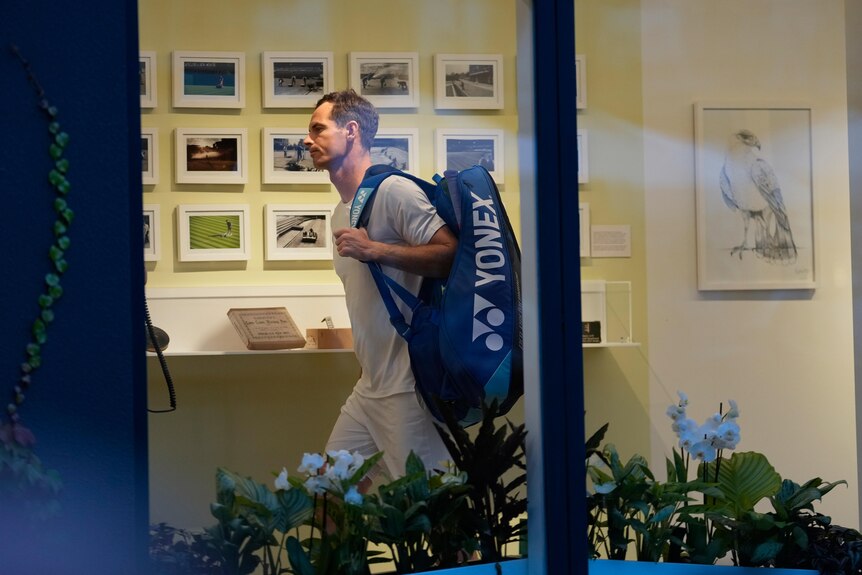 Andy Murray walks with his bag over his shoulder