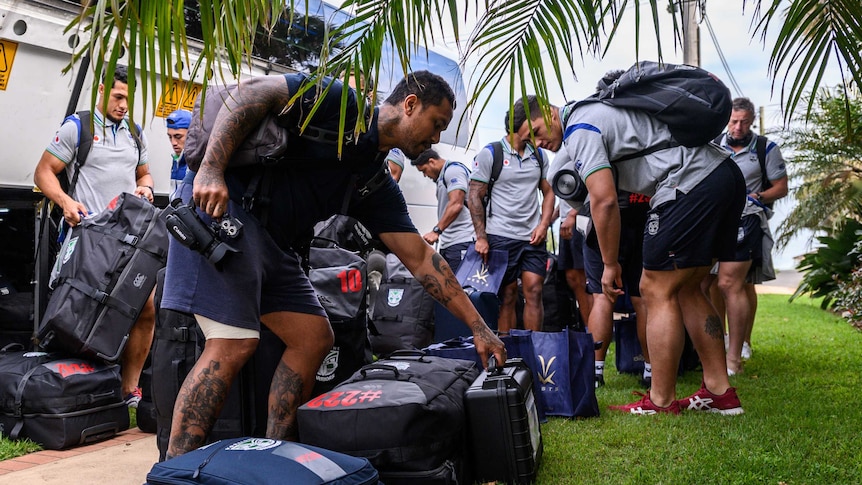 New Zealand Warriors NRL players collect their bags after getting off their bus in Terrigal on the NSW central coast.