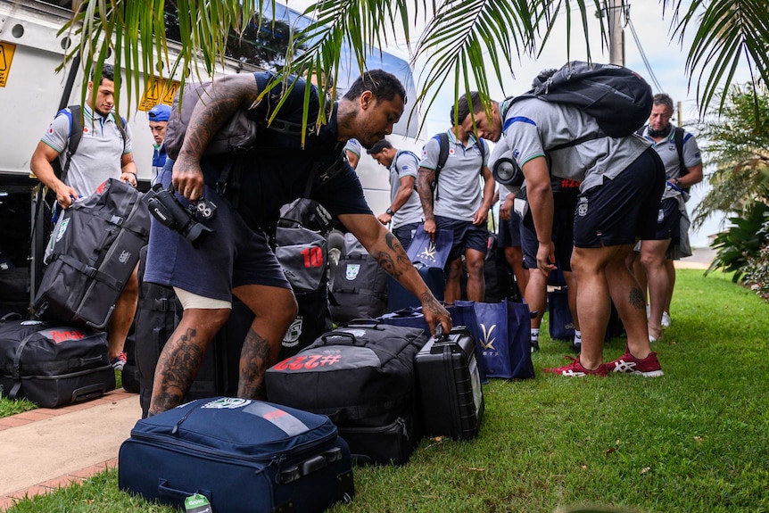 New Zealand Warriors NRL players collect their bags after getting off their bus in Terrigal on the NSW central coast.