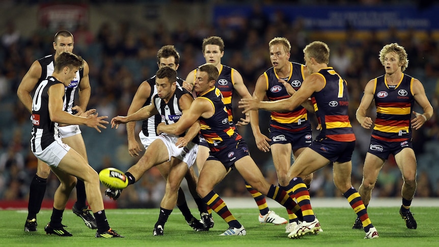 All over them ... the Adelaide defence swarms Collingwood in the ruck at Football Park.