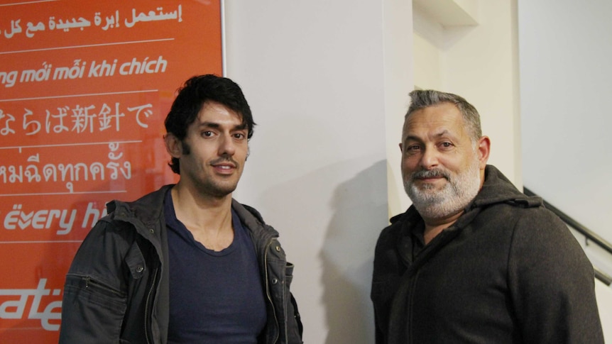 Rami Ghattis and Adam Messede stand and smile at the camera.