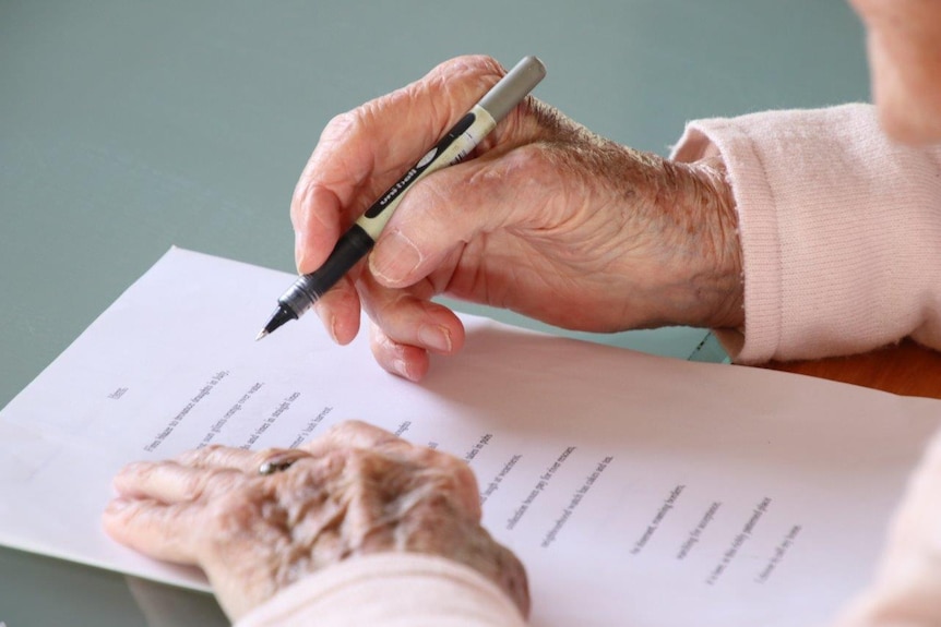 93-year-old Launceston woman writes at her desk