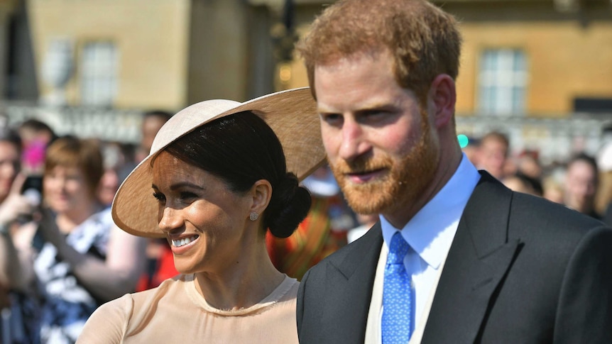 Meghan Markle walking next to Prince Harry.