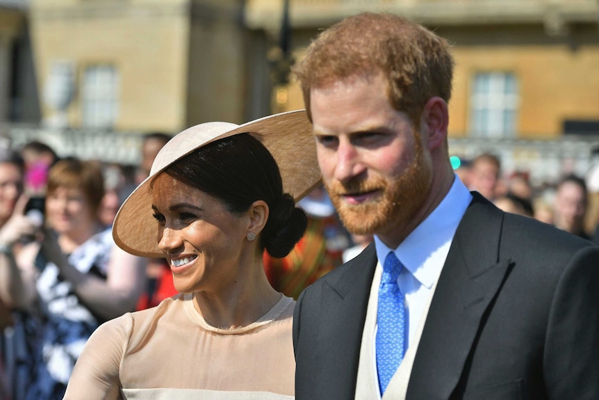 Meghan Markle walking next to Prince Harry.