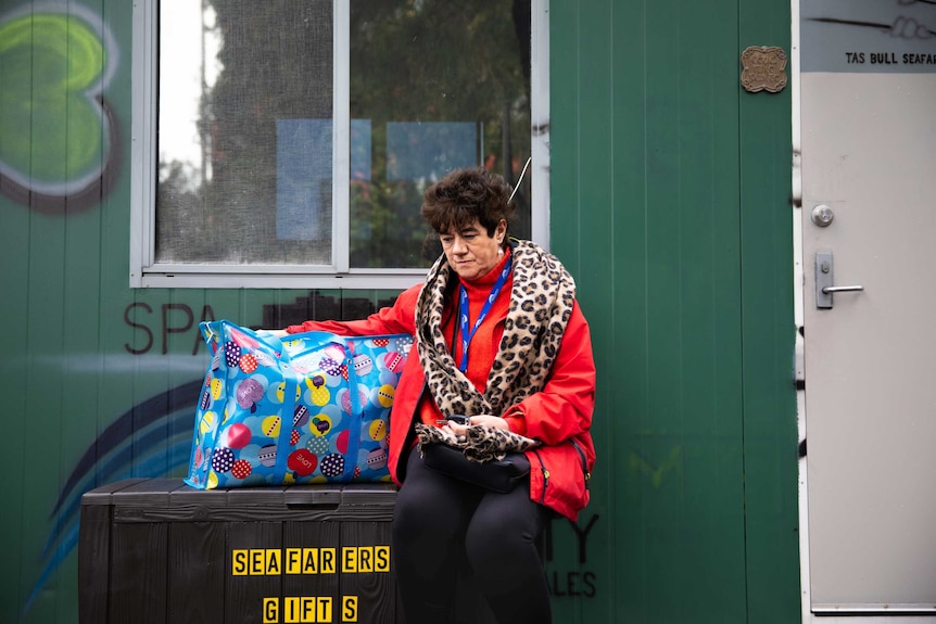 Sister Mary Leahy sits outside the converted shipping container that has become her office.