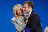 French president-elect Emmanuel Macron and his wife Brigitte hug as he addresses supporters in Paris.
