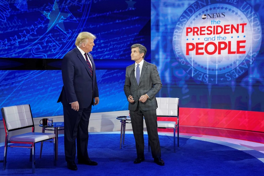 U.S. President Donald Trump takes the stage with ABC News chief anchor George Stephanopoulos